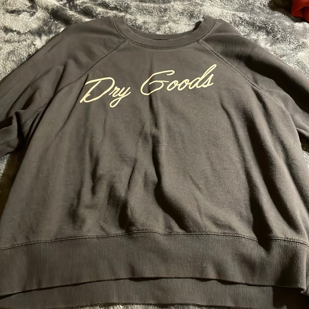 Dark grey, long sleeve, dry goods shirt.